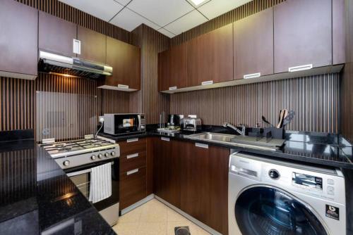 a kitchen with a washer and a washing machine at Special Rates - Elegant Studio - Golf Views in Dubai