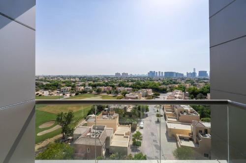 a view of a city from the balcony of a building at Special Rates - Elegant Studio - Golf Views in Dubai