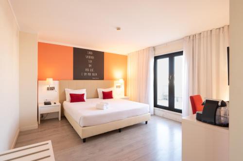 a hotel room with a bed and a tv in it at THE Hotel MASA Almirante LISBON Stylish in Lisbon
