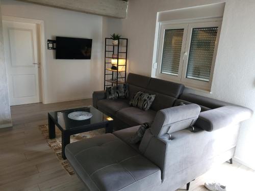 a living room with a couch and a table at Stan na dan BOVKA in Široki Brijeg