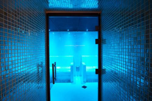 a door leading to a swimming pool at night at Harbour Hotel & Spa Bristol in Bristol