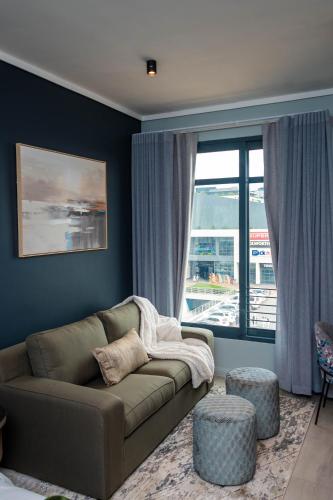 a living room with a couch and a large window at Triple M Luxury in Vosburg
