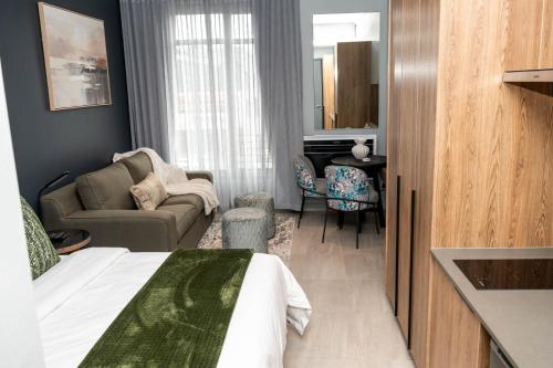 a hotel room with a bed and a living room at Triple M Luxury in Vosburg