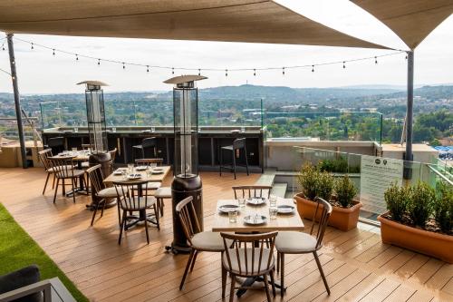 a restaurant with tables and chairs on a deck at Triple M Luxury in Vosburg