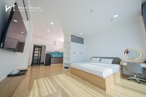 a bedroom with a bed and a desk and a chair at Hotel Initial-Benthanh in Ho Chi Minh City