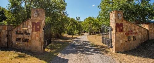 two entrances to a gate on a dirt road at Mendelbaum - Peach Cabin in Fredericksburg