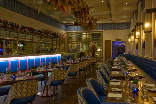 a restaurant with tables and chairs and a bar at Harbour Hotel & Spa Bristol in Bristol