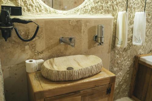 a bathroom with a sink on a wooden counter at Vie Cappadocia - Adults Only in Nevsehir