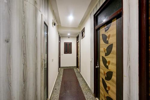 a hallway with wooden doors in a building at Hotel Lookout Stay in New Delhi