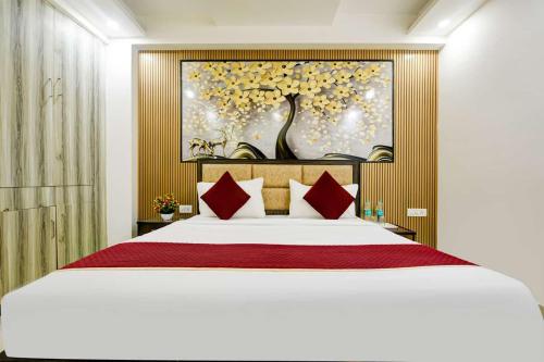 a bedroom with a large bed with red pillows at Hotel Lookout Stay in New Delhi