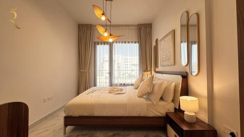 a bedroom with a large bed and a window at Elegant 1BR Blossom Retreat - Masdar City in Abu Dhabi