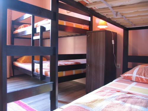 a bedroom with bunk beds with a bed and a lamp at Hostel Musala in Mostar