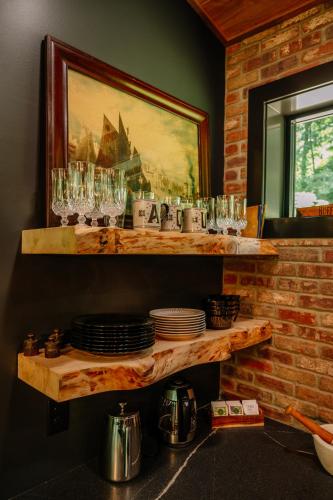 a shelf with glasses and plates on a wall at Whiskey Lounge in Loudonville