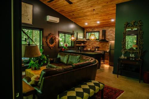 a living room with a couch and a kitchen at Whiskey Lounge in Loudonville