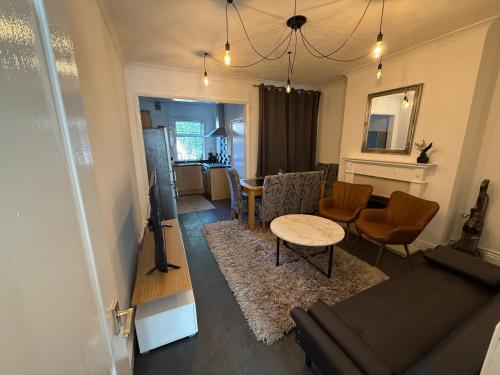 a living room with a couch and a table at 3 Bedroom House - Doncaster Serviced Accommodation - House-Close To Centre -A1 & M18 - Contractors - Business Travellers - Families in Doncaster