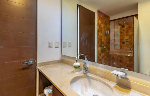 a bathroom with a sink and a shower at Downtown Playa close 5th Av Rooftop Pool in Playa del Carmen