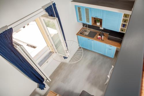 an overhead view of a kitchen with blue cabinets at Nautilus Suites & Rooms in Olbia