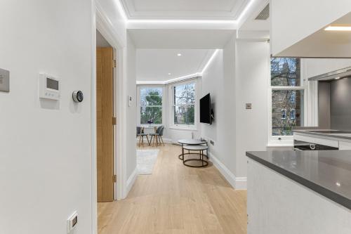 an open kitchen with white walls and a dining room at LuxLet Apartments - Heart of Hampstead, London in London