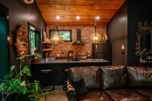 a living room with a couch and a kitchen at Whiskey Lounge in Loudonville