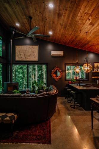 a living room with a large couch and a table at Whiskey Lounge in Loudonville