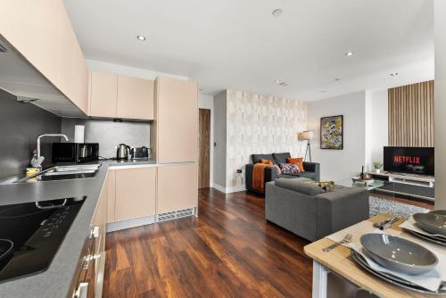 an open kitchen and living room with a couch at The Artist Abode in Central Manchester in Manchester