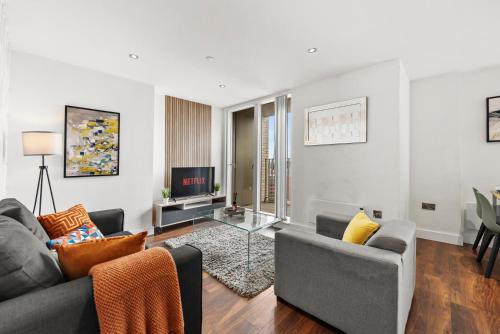 a living room with a couch and a tv at The Artist Abode in Central Manchester in Manchester