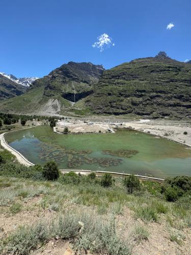a lake in the middle of a mountain at Sun Beam Hotel Koksar in Khoksar