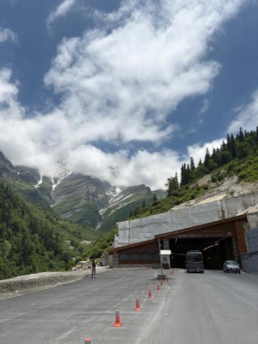 a road with orange cones in front of a tunnel at Sun Beam Hotel Koksar in Khoksar