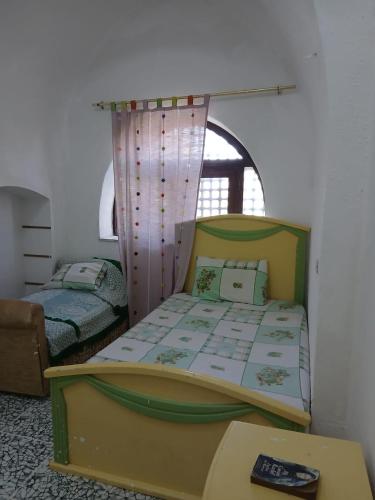 a bedroom with two beds and a table in it at Ma Sou in El Alamein