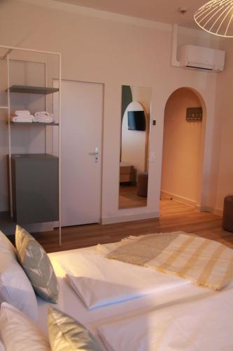 a living room with a couch and a mirror at Gästehaus Centro in Konstanz in Konstanz