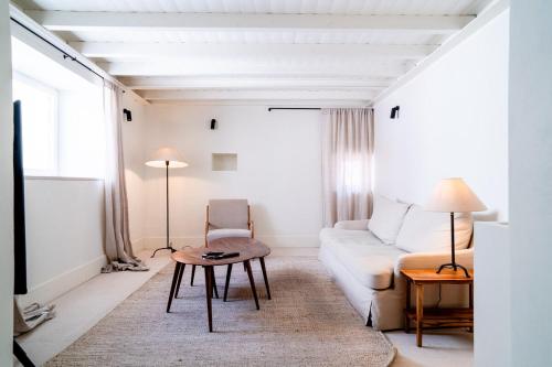 a living room with a couch and a table at Castelo House in Castelo de Vide