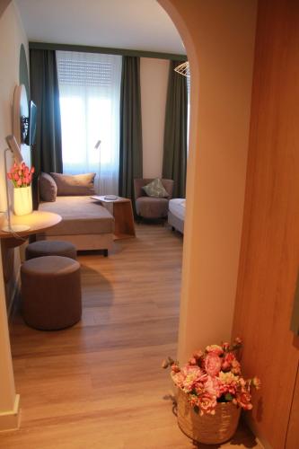 a living room with a couch and a living room with a table at Gästehaus Centro in Konstanz in Konstanz