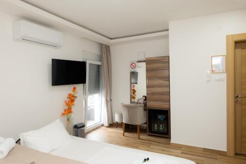 a bedroom with a bed and a tv on the wall at Villa Sweet Dreams in Novi Sad
