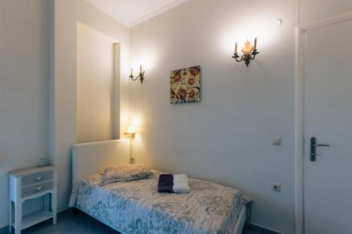 a bedroom with a bed and a picture on the wall at Hotel Villa Sevasti in Katerini