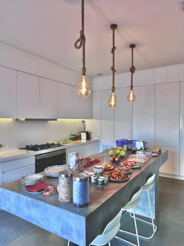 a kitchen with a table with food on it at Bica Vista in Lourinhã