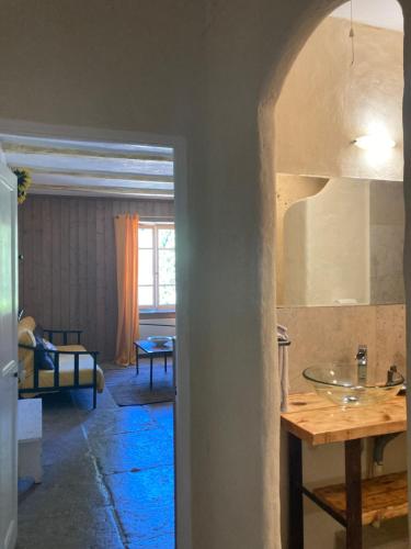a view of a kitchen with a sink and a living room at Le Mas de la Roche in Montbrison-sur-Lez