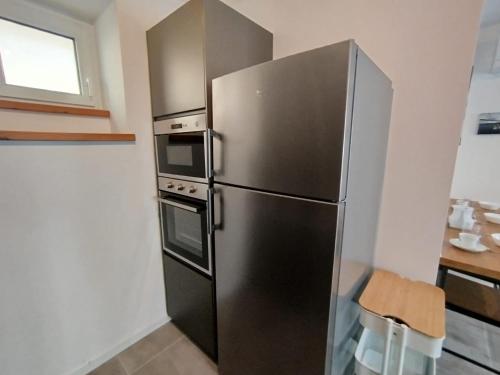 a stainless steel refrigerator in a small kitchen at Affittacamere il Ciliegio in Trieste