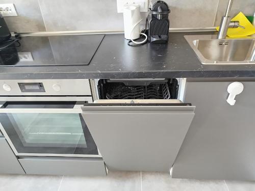 a kitchen with a sink and a counter top at Affittacamere il Ciliegio in Trieste