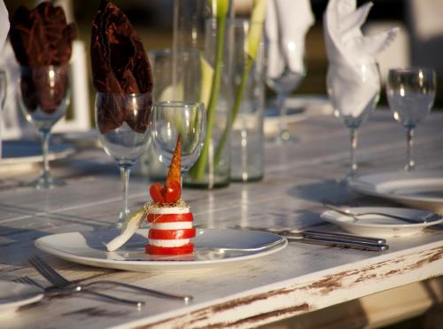 a table topped with a plate with a red and white napkin at Samba Vallarta All Inclusive in Nuevo Vallarta 