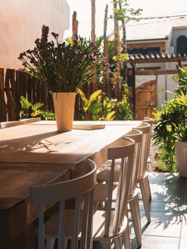 a wooden table with chairs and a potted plant at 6 senses Hoi An Villa luxury 5BR 6bed and 5 minutes to An Bang beach in An Bang