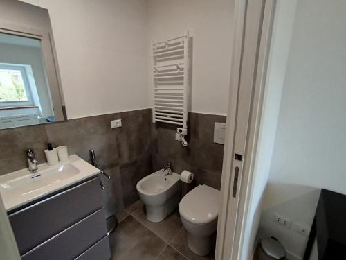 a bathroom with a white toilet and a sink at Affittacamere il Ciliegio in Trieste