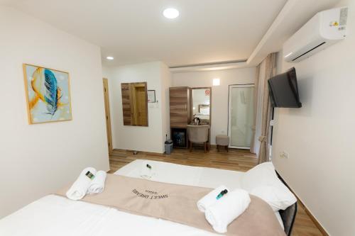 a room with two beds and a television at Villa Sweet Dreams in Novi Sad