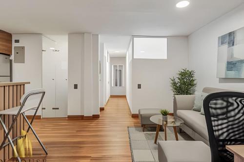 a living room with a couch and a table at Aria Living 201 - Where Design and Location Shine in Guayaquil