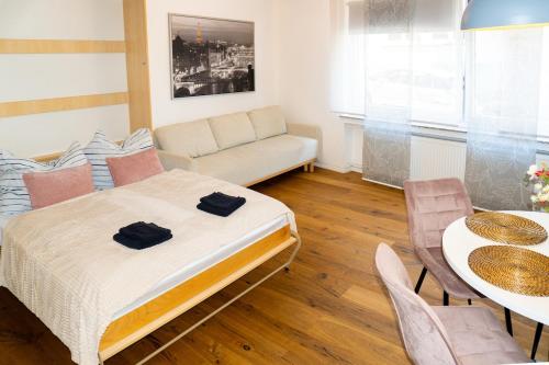 a room with a bed and a couch and a table at Cozy apartment in central location in Wuppertal