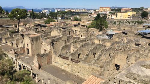 an old stone town with a city in the background at B&B Italia in Ercolano