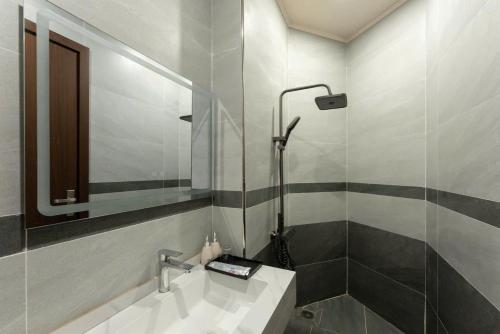 a bathroom with a sink and a shower at Ocean Hotel in Sầm Sơn