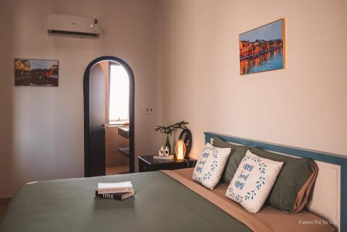a bedroom with a bed with two pillows on it at 6 senses Hoi An Villa luxury 5BR 6bed and 5 minutes to An Bang beach in An Bang