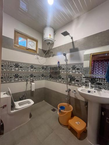a bathroom with a sink and a toilet at Hotel New Infraview - luxuries rooms with Cooled AC in Zirakpur