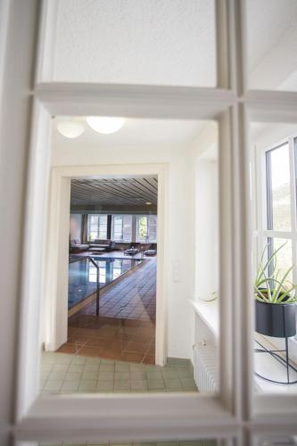 a view of a hallway through a glass door at Boutique-Hotel Weigels Bergfreiheit in Winterberg