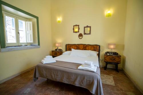 a bedroom with a bed with two towels on it at Charming Rooftop Flat in City Center in Catania